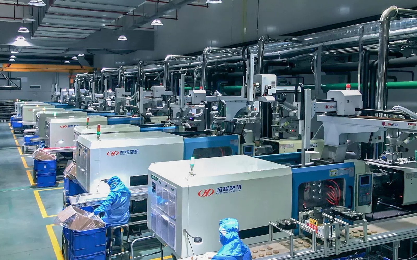 Advanced plastic and glass bottle production machinery in a modern factory setting.